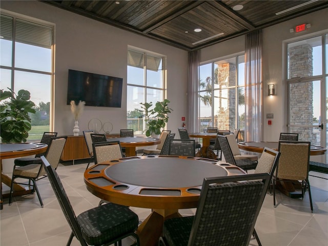 dining area with wood ceiling and light tile patterned flooring