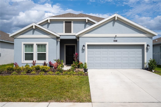 view of front of home featuring a garage, concrete driveway, a front yard, and stucco siding