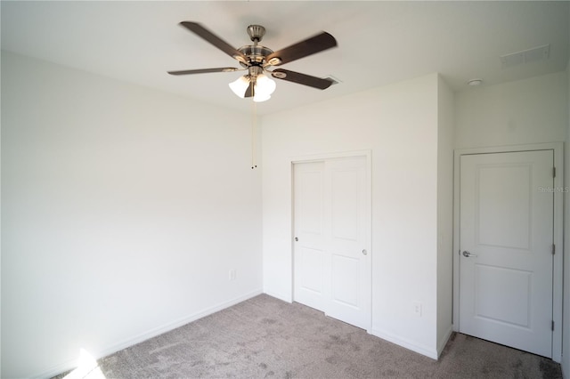 unfurnished bedroom with a ceiling fan, a closet, carpet flooring, and baseboards