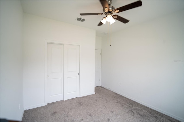 unfurnished bedroom featuring carpet floors, a closet, visible vents, and baseboards