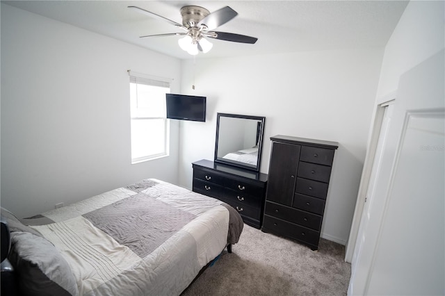 bedroom featuring a ceiling fan and light carpet