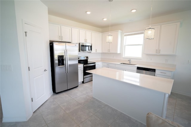 kitchen featuring stainless steel appliances, white cabinetry, and a sink