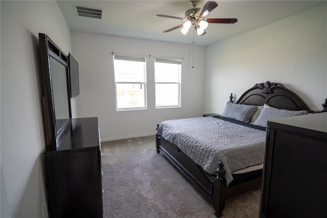 bedroom with baseboards, carpet floors, visible vents, and a ceiling fan