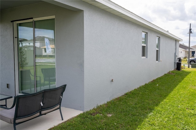 view of property exterior featuring a yard and stucco siding