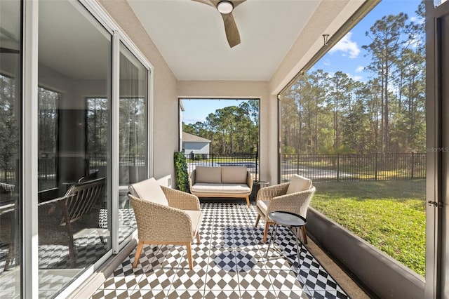 sunroom featuring ceiling fan