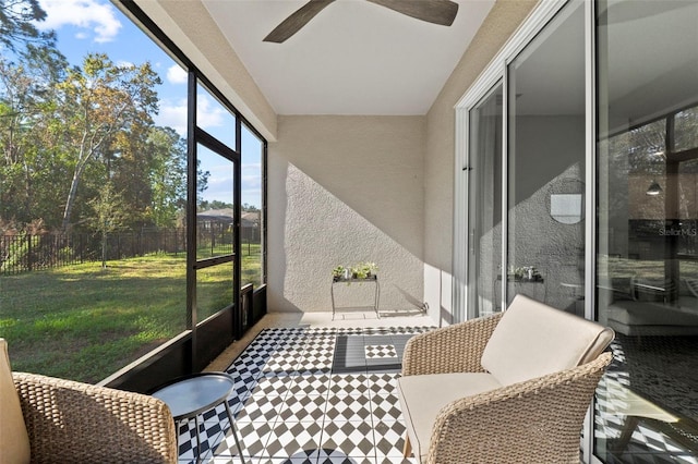 sunroom with a ceiling fan