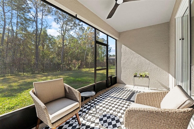 sunroom featuring a ceiling fan