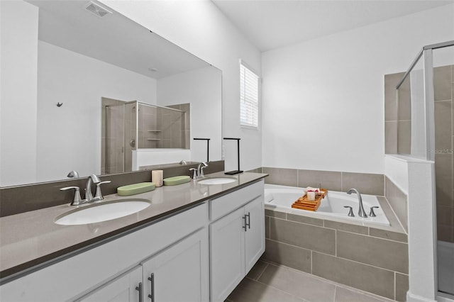 bathroom featuring a garden tub, a stall shower, a sink, and visible vents