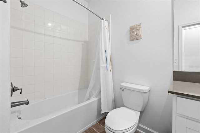 full bathroom with toilet, shower / tub combo, wood finished floors, vanity, and baseboards