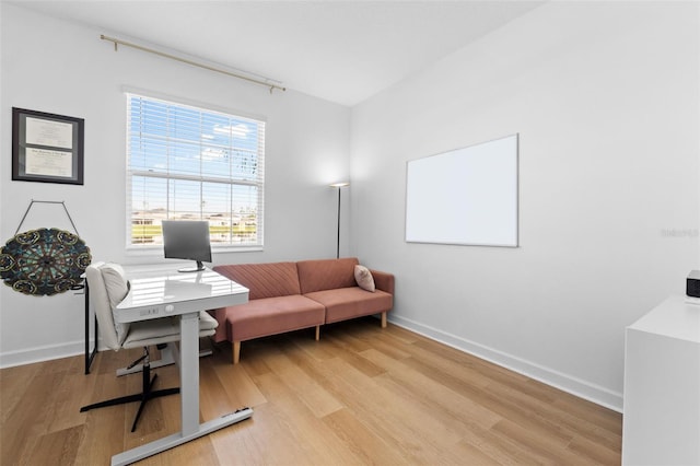 office area with light wood finished floors and baseboards