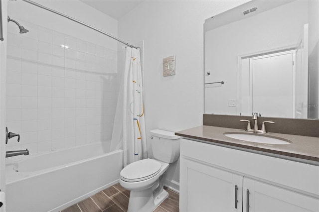 full bath with wood finish floors, visible vents, toilet, shower / tub combo, and vanity