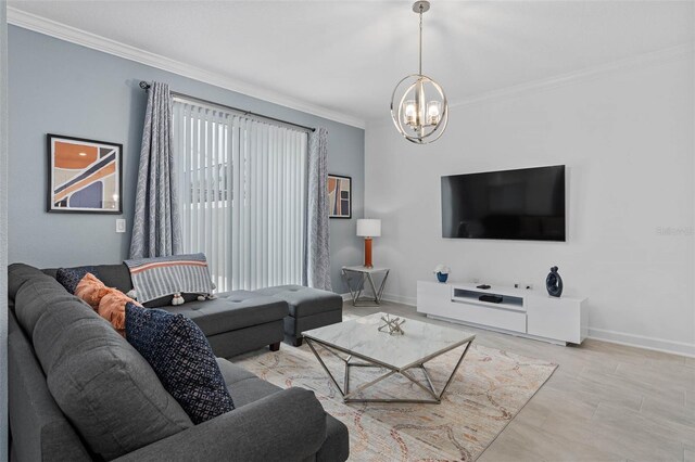 living area with crown molding, baseboards, and a chandelier