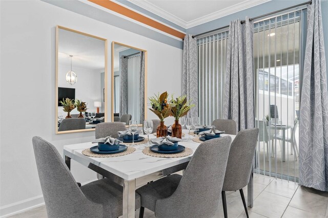 dining area featuring baseboards, an inviting chandelier, and ornamental molding