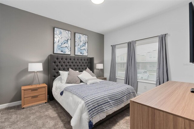 carpeted bedroom featuring baseboards