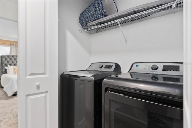 laundry area with carpet, laundry area, and separate washer and dryer