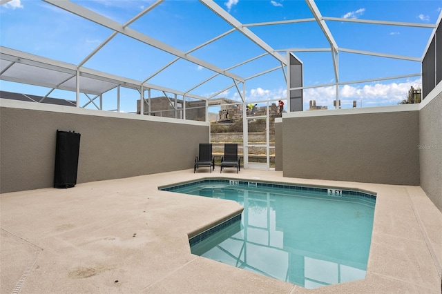 community pool featuring a lanai and a patio area