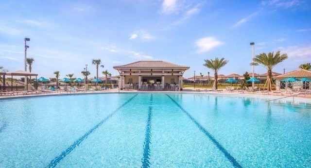 pool with a patio area and a gazebo