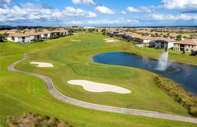 drone / aerial view featuring a residential view, a water view, and view of golf course