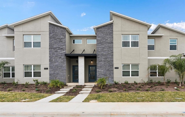 view of front of property with stone siding and stucco siding