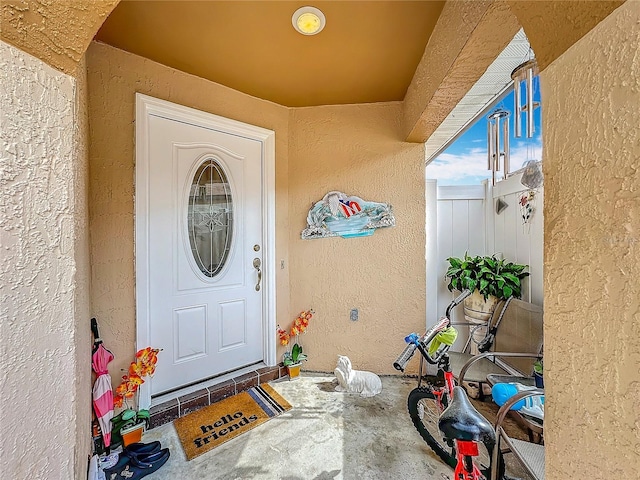 entrance to property featuring stucco siding