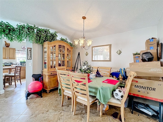 dining room featuring a chandelier, light tile patterned floors, and a textured ceiling