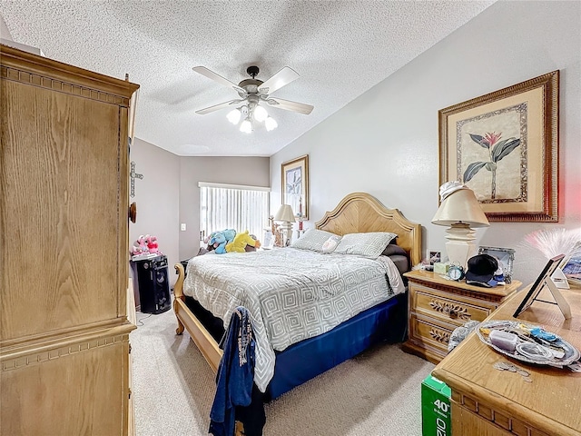 bedroom with ceiling fan, a textured ceiling, and light colored carpet