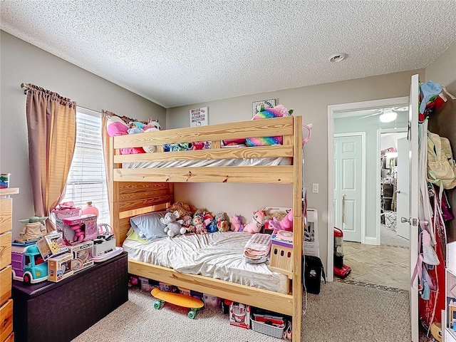 carpeted bedroom featuring a textured ceiling