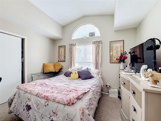 carpeted bedroom with lofted ceiling