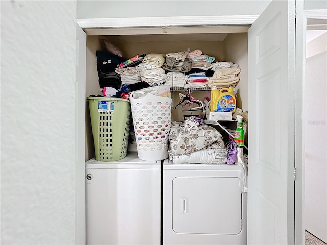 washroom featuring laundry area and washing machine and clothes dryer