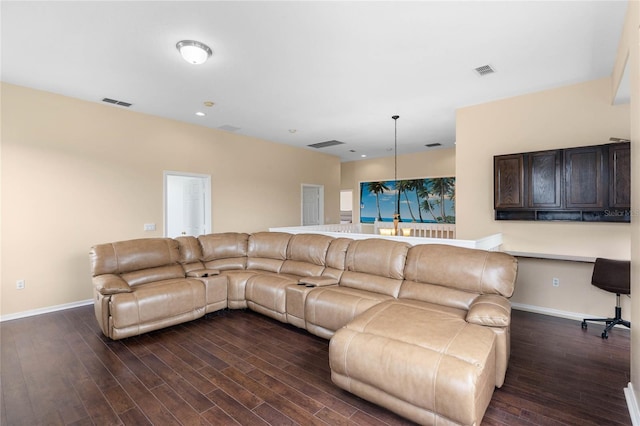 living area featuring baseboards, visible vents, dark wood finished floors, and built in study area