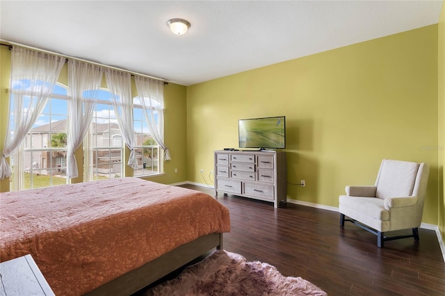 bedroom featuring baseboards and wood finished floors