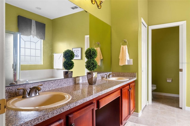 bathroom featuring toilet, double vanity, a sink, and visible vents