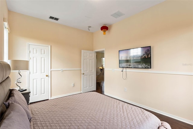 bedroom with visible vents, dark carpet, and baseboards