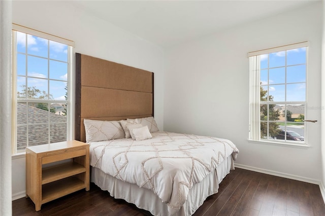 bedroom featuring dark wood-type flooring and baseboards