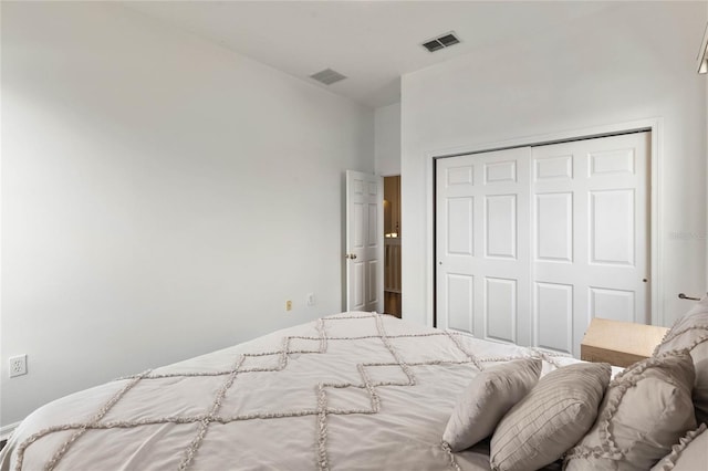 bedroom with a closet and visible vents