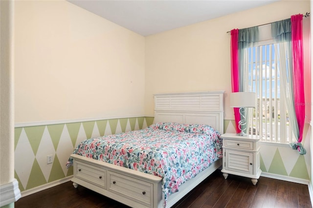 bedroom with baseboards and dark wood-style flooring