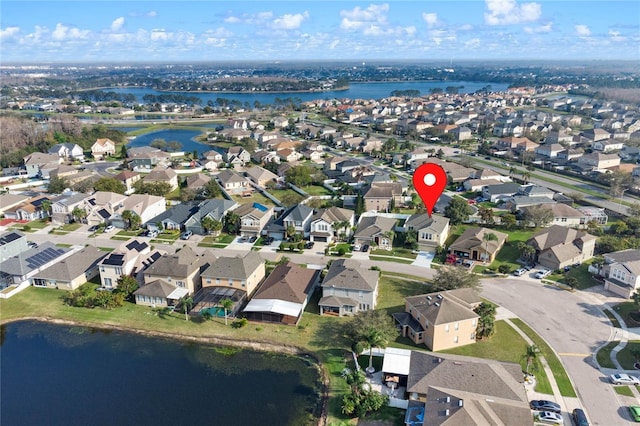 drone / aerial view with a water view and a residential view