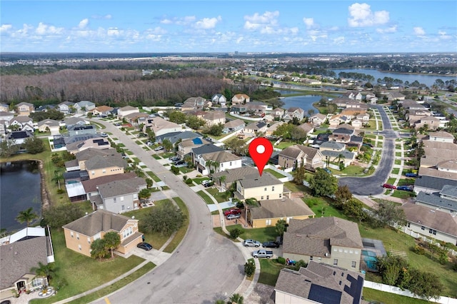 drone / aerial view featuring a water view and a residential view