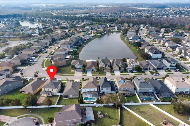 drone / aerial view featuring a water view and a residential view