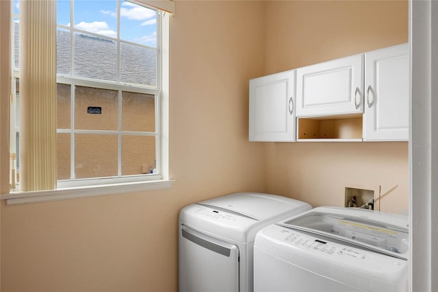 laundry area with washing machine and dryer and cabinet space