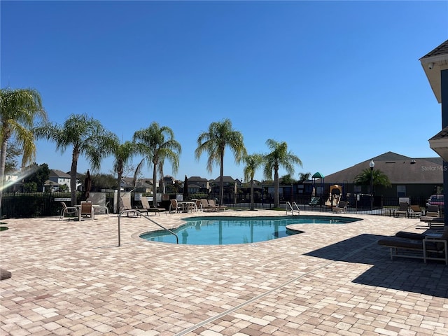 pool featuring a patio area and fence