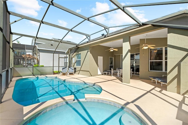 view of pool with a ceiling fan, a pool with connected hot tub, a patio, and a lanai