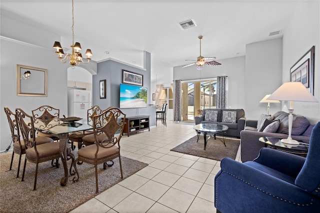 dining room with light tile patterned floors, ceiling fan with notable chandelier, and visible vents