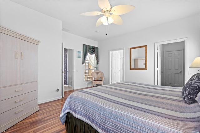 bedroom with wood finished floors, a ceiling fan, and baseboards