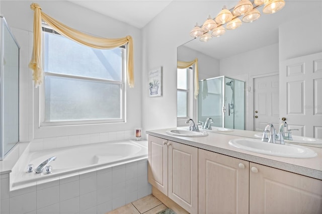 full bathroom with a stall shower, double vanity, a sink, and a bath