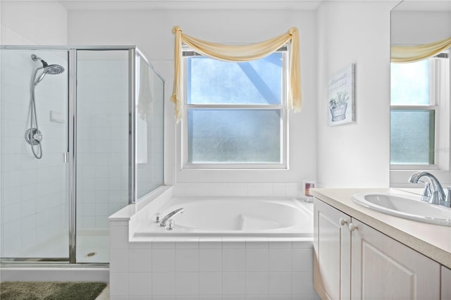 bathroom featuring vanity, a shower stall, and a bath