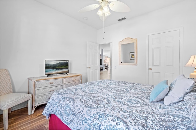 bedroom with visible vents, ceiling fan, and wood finished floors