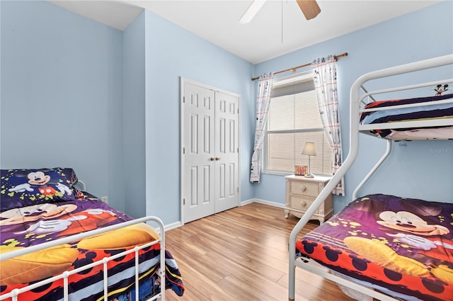 bedroom featuring a closet, ceiling fan, baseboards, and wood finished floors