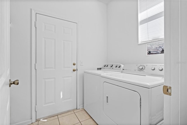 laundry room with laundry area, light tile patterned floors, and washer and clothes dryer