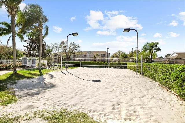 view of community with volleyball court and fence